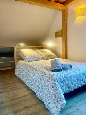 Un ou plusieurs lits dans un hébergement de l'établissement Meublé de la Doller - Chalet au bord de l’eau