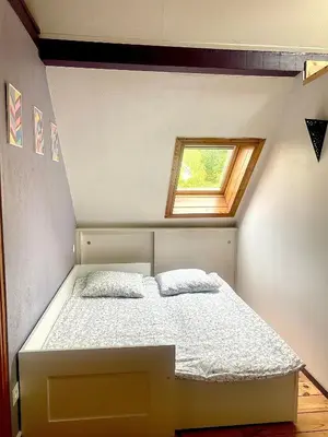 Un ou plusieurs lits dans un hébergement de l'établissement Meublé de la Doller - Chalet au bord de l’eau