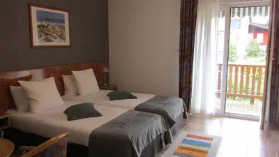 Un ou plusieurs lits dans un hébergement de l'établissement Hôtel sud alsace