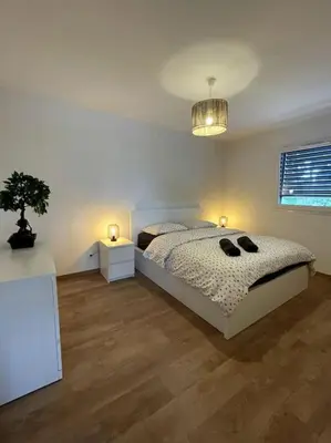Un ou plusieurs lits dans un hébergement de l'établissement Magnifique appartement à la frontière suisse