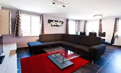 Coin salon dans l'établissement Appartements Le Hupsa Pfannala