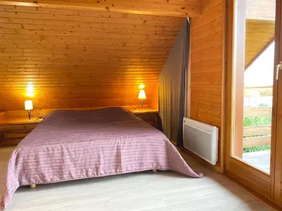 Un ou plusieurs lits dans un hébergement de l'établissement Chalet Miel