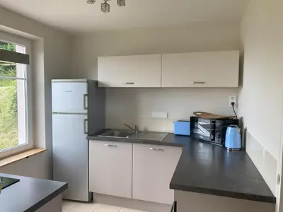Cuisine ou kitchenette dans l'établissement La Maison Rose - La Bresse