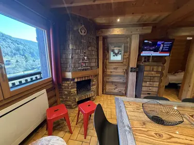 Télévision ou salle de divertissement dans l'établissement LE GRAND CERF Chalet en rondins avec SPA Jacuzzi