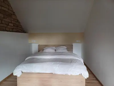 Un ou plusieurs lits dans un hébergement de l'établissement Les chambres du Haras St Georges