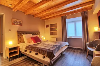 Un ou plusieurs lits dans un hébergement de l'établissement Le Repaire de l'Ours - L'Alcôve de l'Ours - Chambre cosy 2 pers