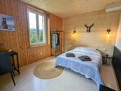Un ou plusieurs lits dans un hébergement de l'établissement Appartement Chaleureux Gérardmer proche forêt
