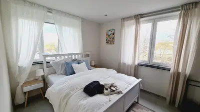 Un ou plusieurs lits dans un hébergement de l'établissement Le Loft de Village-Neuf - Résidence 4 étoiles