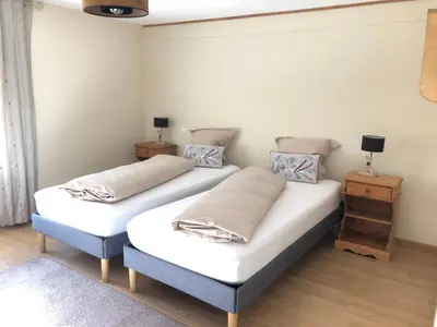 Un ou plusieurs lits dans un hébergement de l'établissement La Ferme 1807 Vosges, jacuzzi, sauna, pétanque