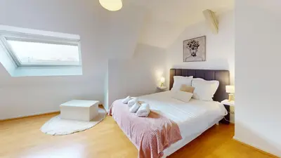 Un ou plusieurs lits dans un hébergement de l'établissement Triplex Le Bel Âtre