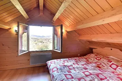 Un ou plusieurs lits dans un hébergement de l'établissement Chalet Charmilles - Chalet vue sur montagne