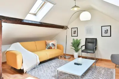 Coin salon dans l'établissement Le CLOONEY - appartement en duplex - Hyper centre