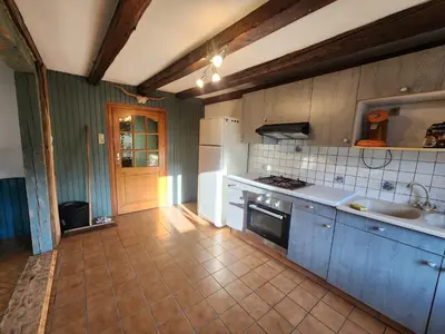 Cuisine ou kitchenette dans l'établissement Maison de Vacances