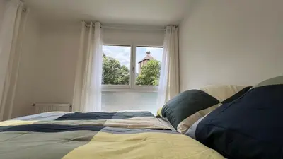 Un ou plusieurs lits dans un hébergement de l'établissement Room with double size bed in Kaysersberg center
