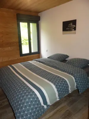 Un ou plusieurs lits dans un hébergement de l'établissement LE MASSIF - Appartements tout confort avec vue