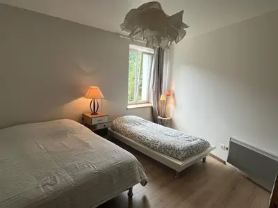 Un ou plusieurs lits dans un hébergement de l'établissement Appartement 5 personnes avec espace plein air