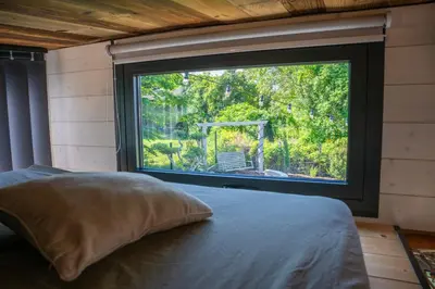 Un ou plusieurs lits dans un hébergement de l'établissement Tiny House des Cigognes