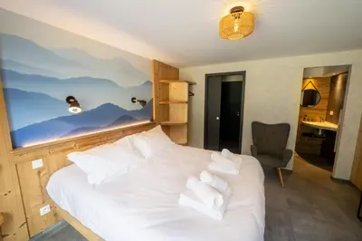 Un ou plusieurs lits dans un hébergement de l'établissement Chalet némésia avec spa à Gérardmer