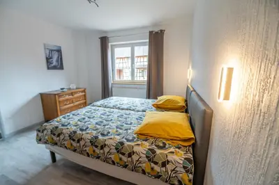 Un ou plusieurs lits dans un hébergement de l'établissement Gîte A l'ombre du clocher