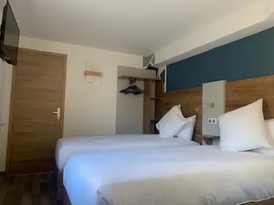 Un ou plusieurs lits dans un hébergement de l'établissement Val Hôtel Montbéliard Sud