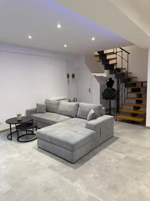 Coin salon dans l'établissement Appartement Le Belarya