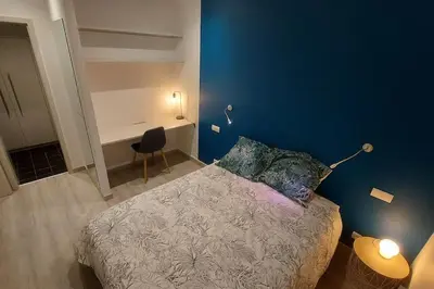 Un ou plusieurs lits dans un hébergement de l'établissement Maison La Belfort You proche TechnHom