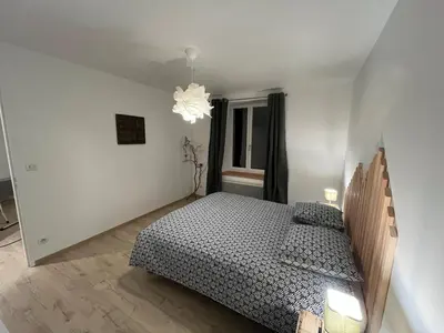 Un ou plusieurs lits dans un hébergement de l'établissement Naturel loft 5 personnes et jardin