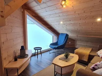 Coin salon dans l'établissement Chalet Nature avec Sauna et WIFI près Gérardmer - FR-1-589-777