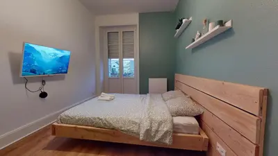 Un ou plusieurs lits dans un hébergement de l'établissement Le Majestic & Pool Mulhouse