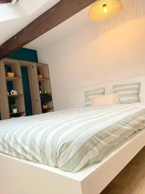 Un ou plusieurs lits dans un hébergement de l'établissement Cosy et Bel Appart paisible