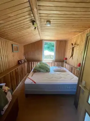 Un ou plusieurs lits dans un hébergement de l'établissement chalet cosy au calme