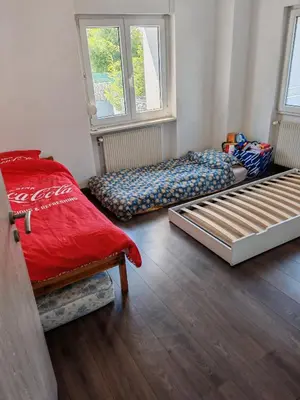 Un ou plusieurs lits dans un hébergement de l'établissement Appartement proche Aéroport