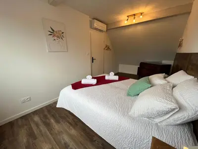 Un ou plusieurs lits dans un hébergement de l'établissement La Cour de Mamama Appartement 4