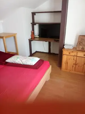 Un ou plusieurs lits dans un hébergement de l'établissement Chambre dans une appartement