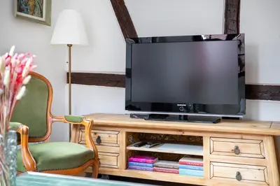 Télévision ou salle de divertissement dans l'établissement Gîte Chez Madeleine en plein coeur de Rouffach