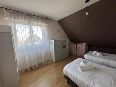 Un ou plusieurs lits dans un hébergement de l'établissement Vogelgarten - Maison de vacances entre vignes, et chants d'oiseaux