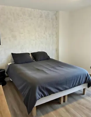 Un ou plusieurs lits dans un hébergement de l'établissement Appartement Porte Jeune - 3 Chambres Balcon Fibre Netflix