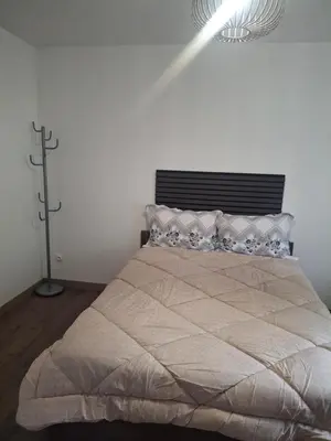 Un ou plusieurs lits dans un hébergement de l'établissement Appartement T3 conviviale avec terrasse