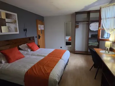 Un ou plusieurs lits dans un hébergement de l'établissement Hôtel Restaurant AU SOLEIL