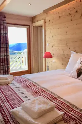 Un ou plusieurs lits dans un hébergement de l'établissement Holiday Home Chalet Le Flocon Bleu mit Blick auf das Wasser by Interhome