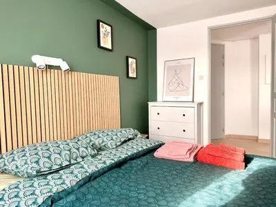 Un ou plusieurs lits dans un hébergement de l'établissement Cozy Apartment city center