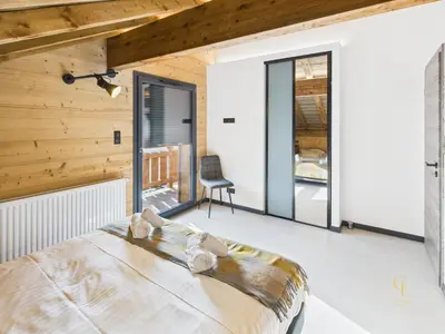 Un ou plusieurs lits dans un hébergement de l'établissement Le Chalet des Chéneaux - Neuf avec Jacuzzi