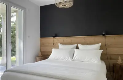 Un ou plusieurs lits dans un hébergement de l'établissement Appartement avec jardin privatif Gérardmer