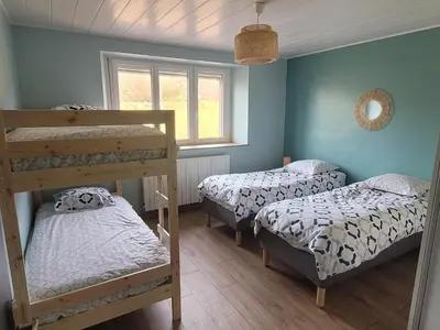 Un ou plusieurs lits dans un hébergement de l'établissement Location 12 personnes SPA pêche chez Mémère Hélène