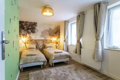 Un ou plusieurs lits dans un hébergement de l'établissement Maison cosy avec terrasse au cœur de Munster