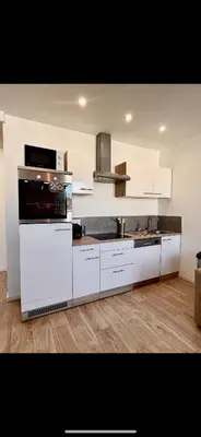 Cuisine ou kitchenette dans l'établissement T2 proche centre, parc expo, Netflix