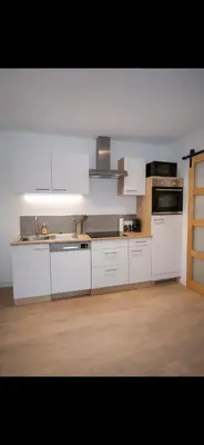 Cuisine ou kitchenette dans l'établissement 2 pièces proche centre et parc expo