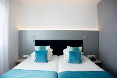 Un ou plusieurs lits dans un hébergement de l'établissement Colmar Hotel