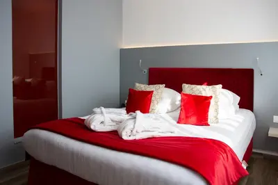 Un ou plusieurs lits dans un hébergement de l'établissement Colmar Hotel
