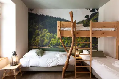 Un ou plusieurs lits dans un hébergement de l'établissement Appartement A Travers Champs avec Sauna et Parking